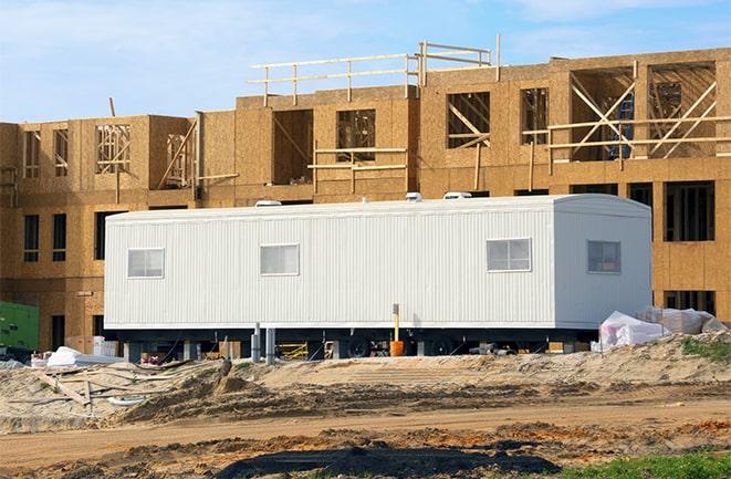 crane lifting modular building for construction office rentals in Ardsley